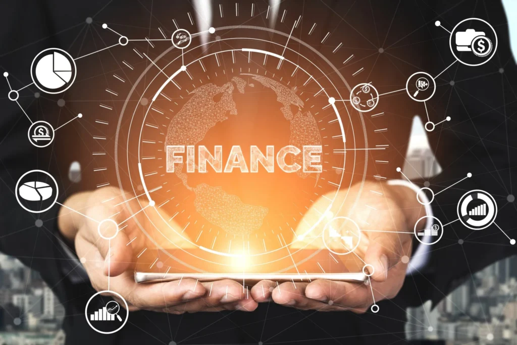 Hands holding a glowing tablet with the word 'FINANCE' surrounded by a globe and interconnected financial icons, representing global financial technology.
